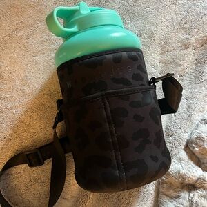 Teal hydrojug and black leopard sleeve